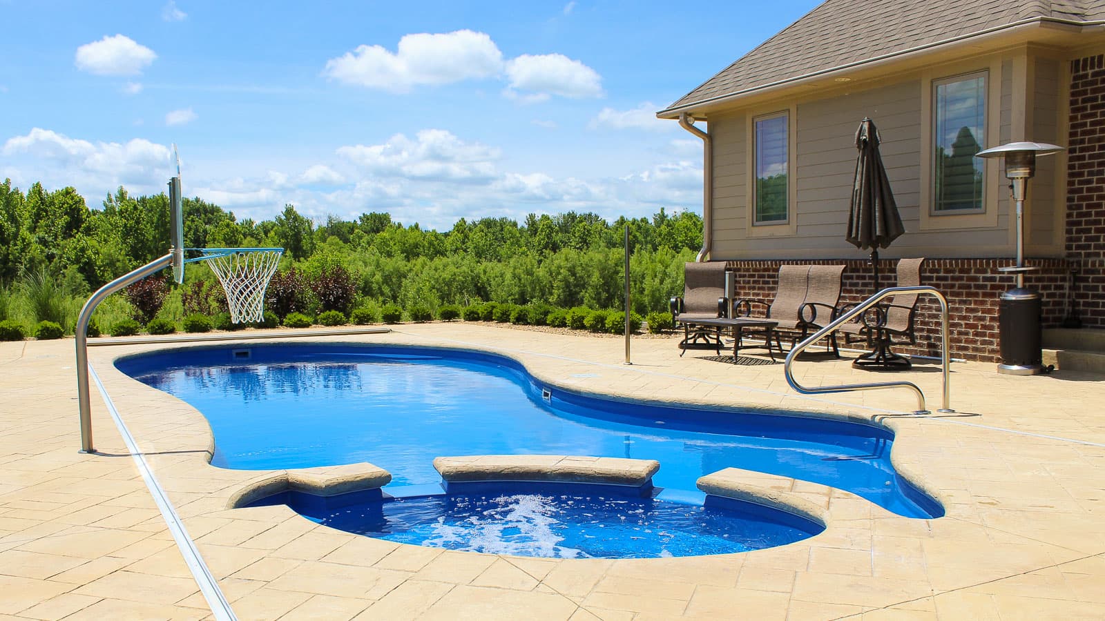 Imagine Pools Brilliant freeform pool model with built-in spa in Ocean Blue color