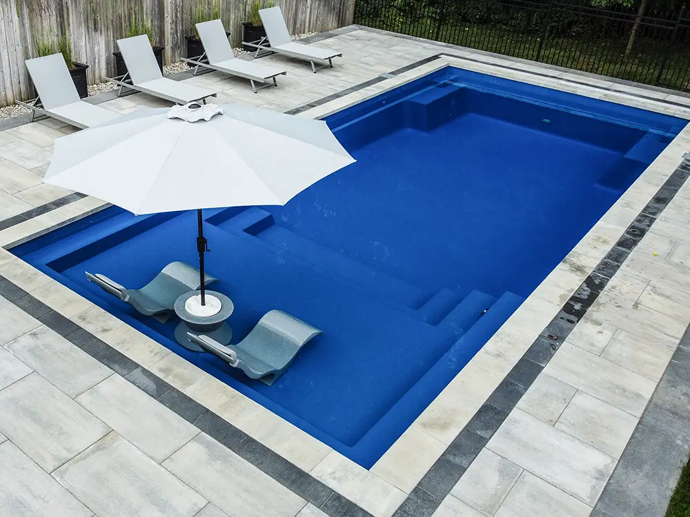 This stylish fiberglass pool radiates an aura of timeless beauty