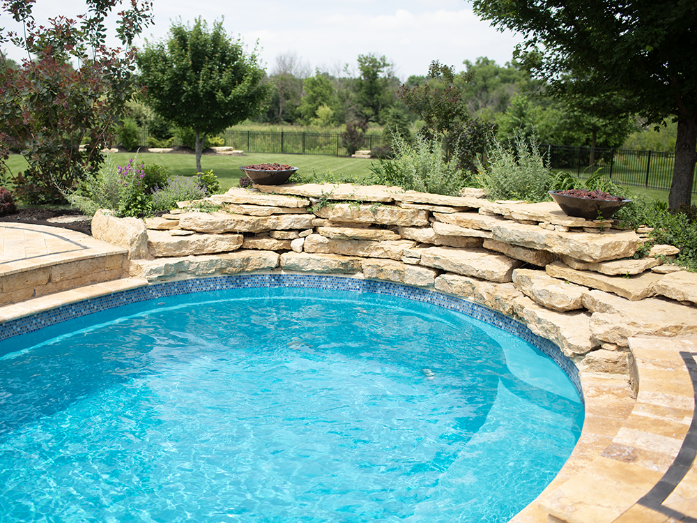 A natural rock formation, in combination with an Imagine Pools fiberglass swimming pool
