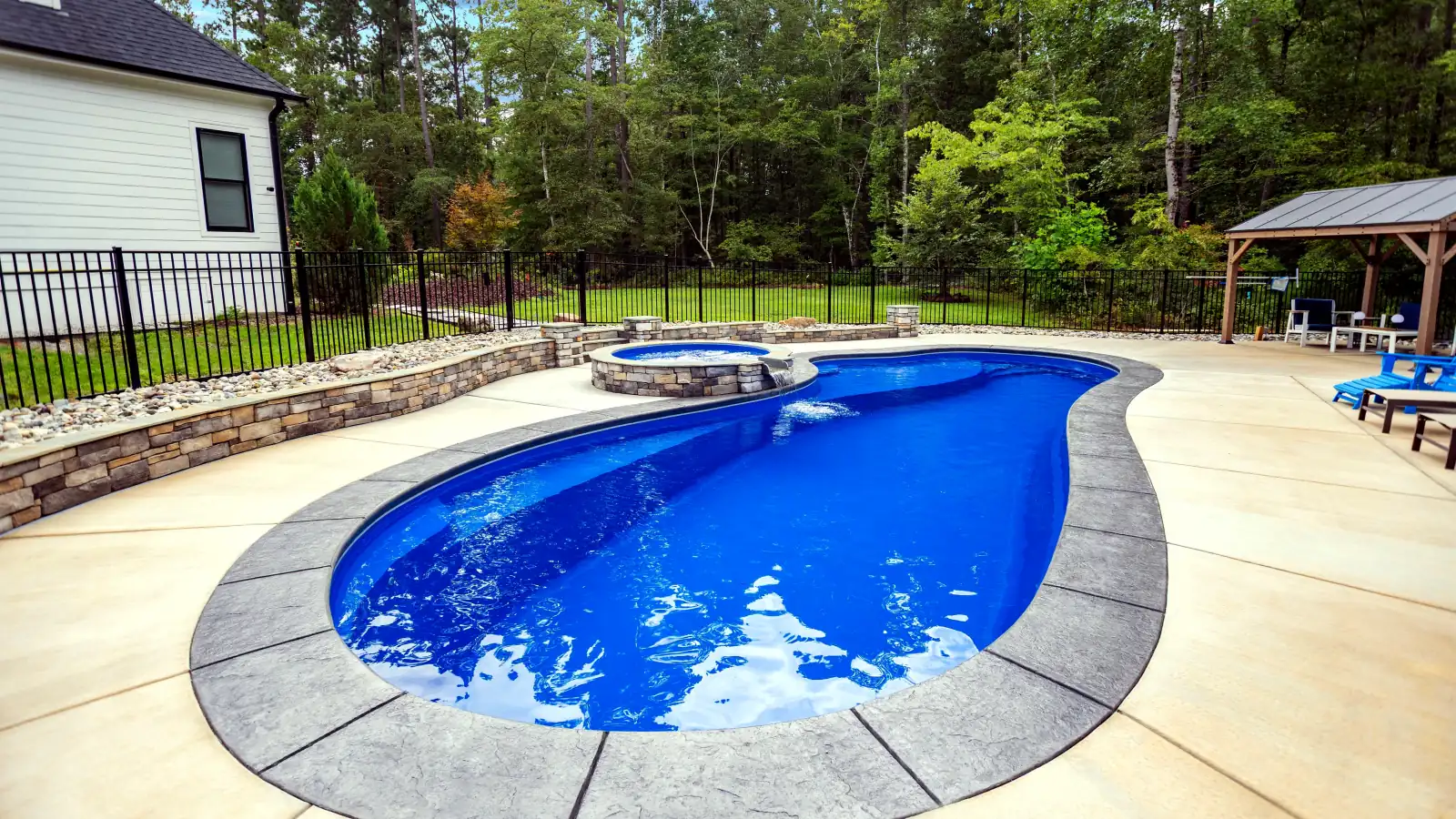 Imagine Pools Inspiration fiberglass pool and spa, angled backyard view