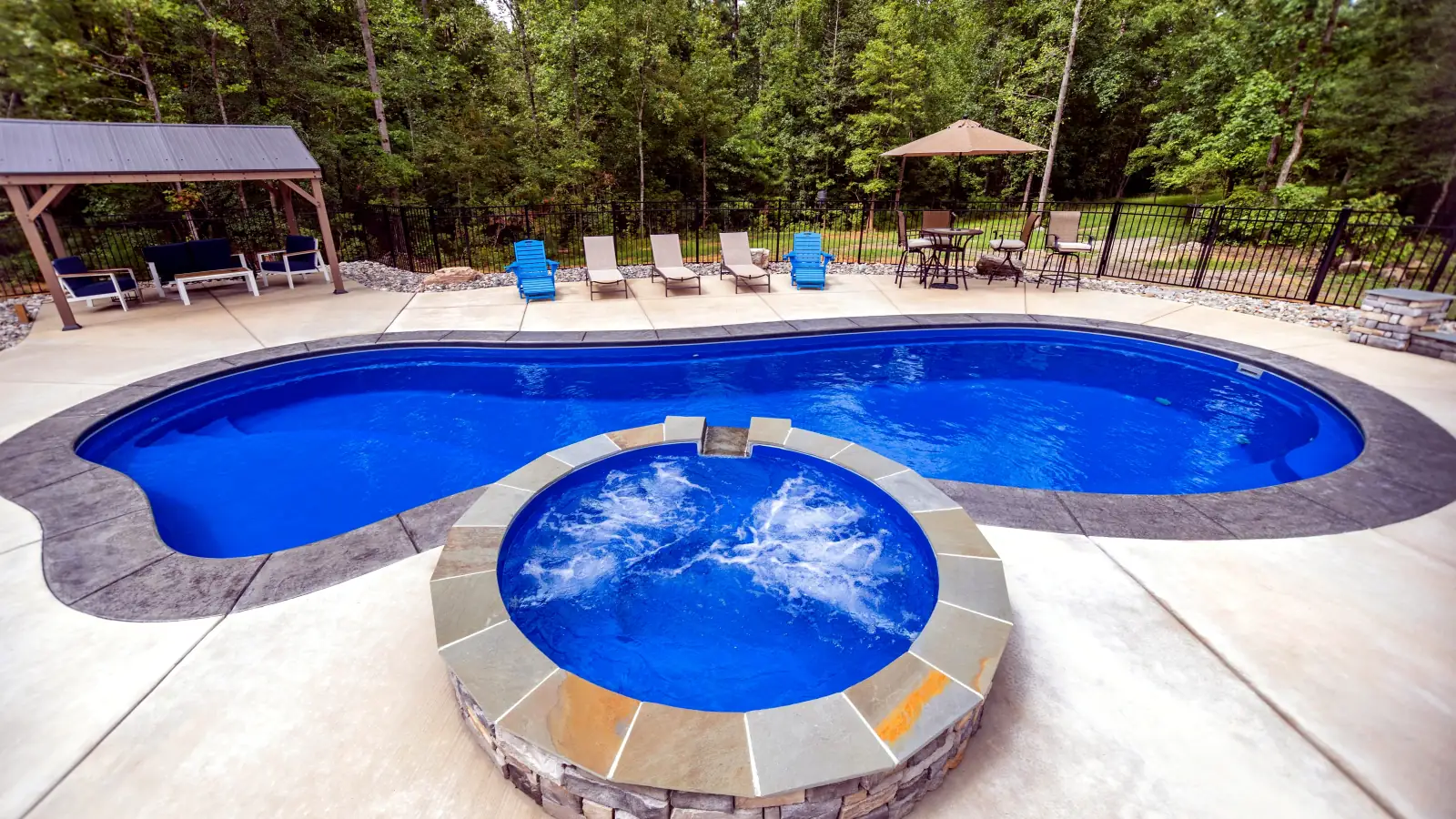 Imagine Pools Inspiration fiberglass pool and round spa, side view