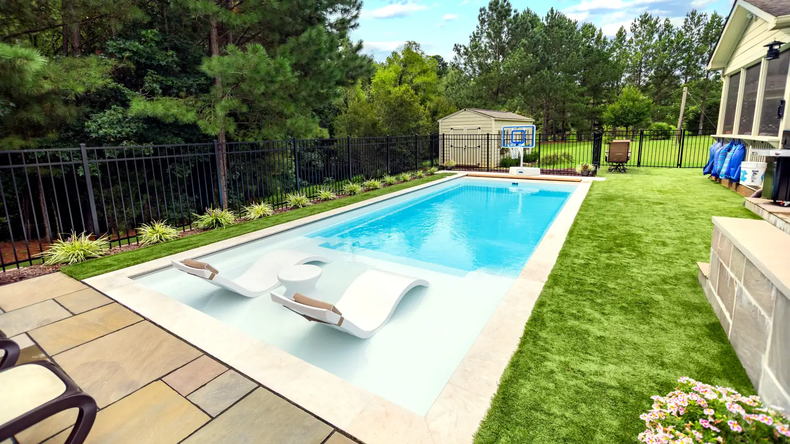 Imagine Pools Freedom with Splash Pad fiberglass pool, angled backyard view